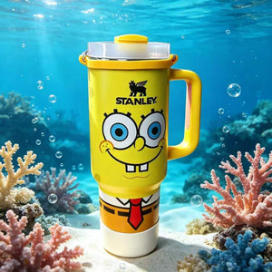 Stanley 40oz insulated tumbler featuring SpongeBob-inspired artwork, underwater ocean background, yellow ergonomic handle, and cartoon-themed design