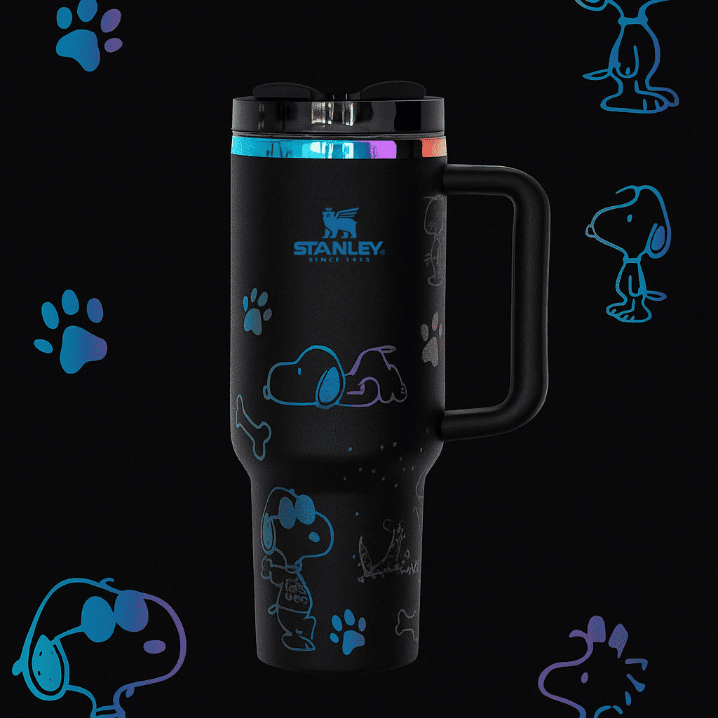 Black Stanley mug with Snoopy designs on a black background with Snoopy illustrations.