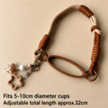 Brown and beige braided keychain with cup holder on a beige background