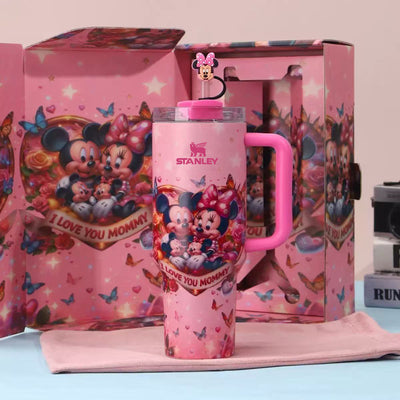 Pink Stanley tumbler with Minnie Mouse design in front of a colorful box