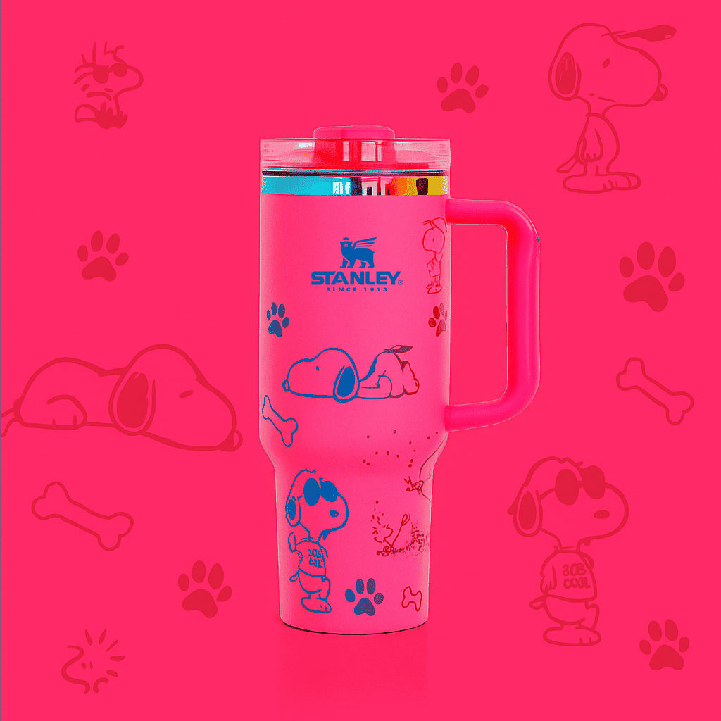 Pink Stanley tumbler with Snoopy illustrations on a pink background with dog-related graphics.