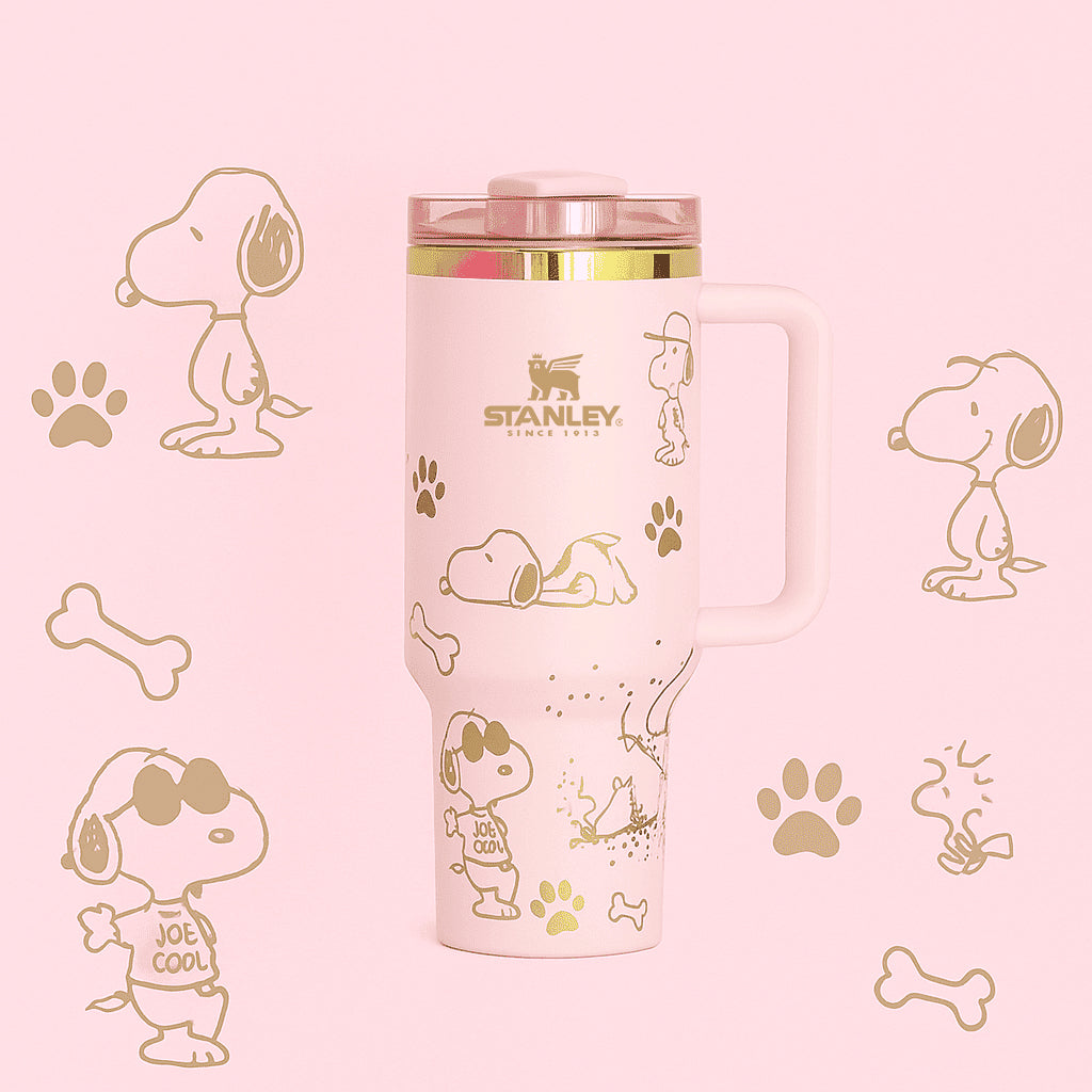 Pink Stanley tumbler with Snoopy illustrations on a pink background