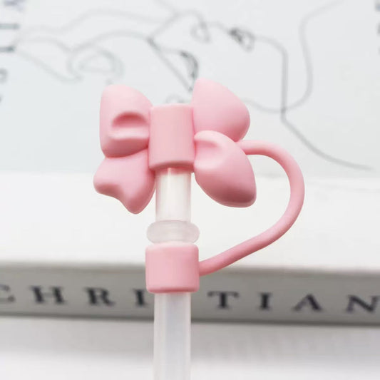 Pink bow-shaped straw holder on a white background
