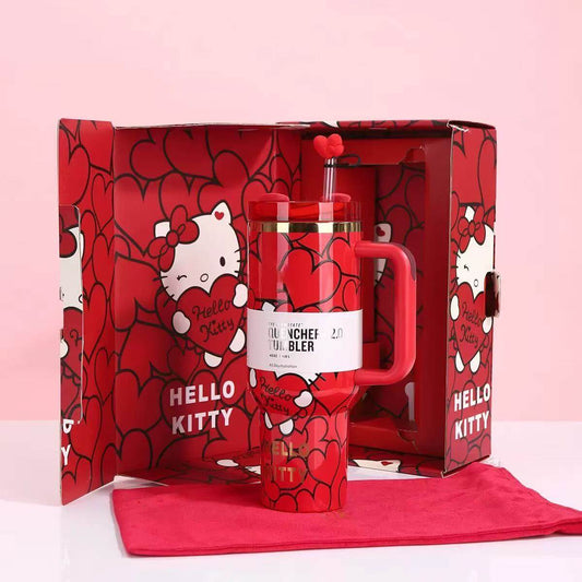 Red 'Hello Kitty' themed lunch set with a lunch bag and bottle in a decorative box on a pink background.
