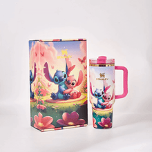 Stanley tumbler with cartoon character design next to its packaging on a white background