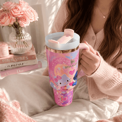 STANLEY tumbler featuring Stitch and Kitty-inspired artwork with pink hearts, pastel colors, insulated construction, large handle, and collectible design.