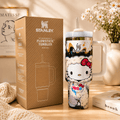 Stanley tumbler with Hello Kitty design next to its packaging on a wooden surface.