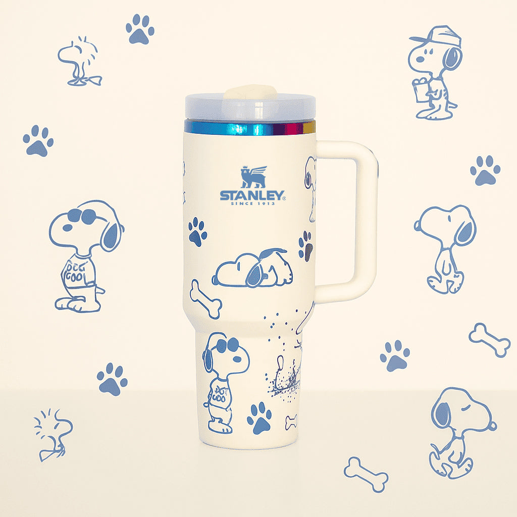 Stanley tumbler with Snoopy illustrations on a patterned background