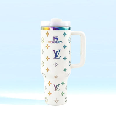 White tumbler with colorful logos on a light blue background